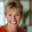 Portrait of Emily R., a friendly woman in her early 40s with a cheerful expression.